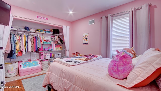 bedroom featuring visible vents and light wood-style flooring