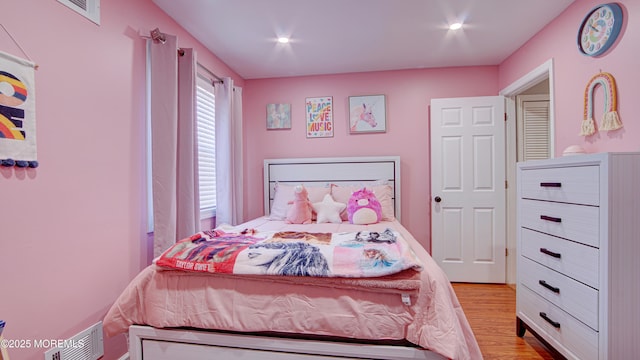 bedroom with visible vents, light wood-style flooring, and recessed lighting