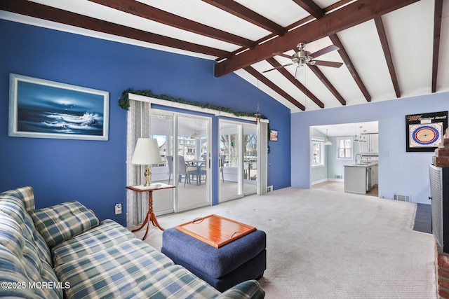 living room with carpet floors, vaulted ceiling with beams, and ceiling fan