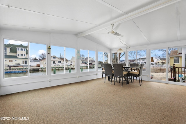 sunroom / solarium featuring vaulted ceiling with beams, a water view, and ceiling fan