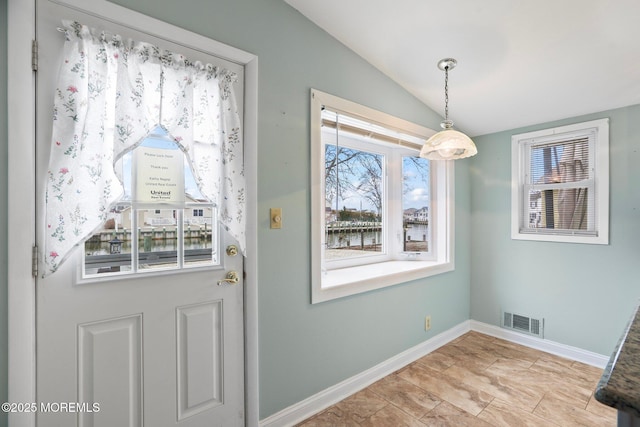 entryway with visible vents, vaulted ceiling, and baseboards