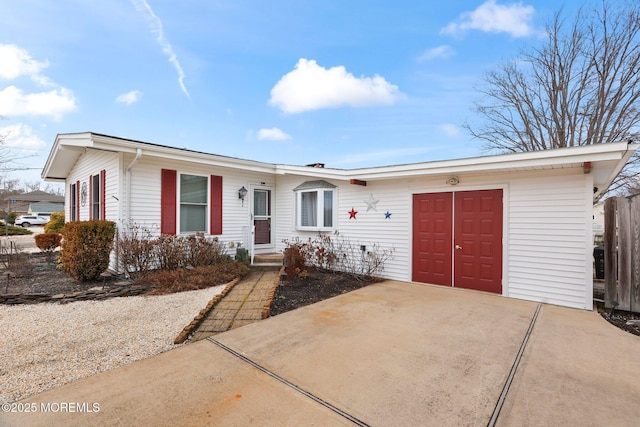 ranch-style home with concrete driveway