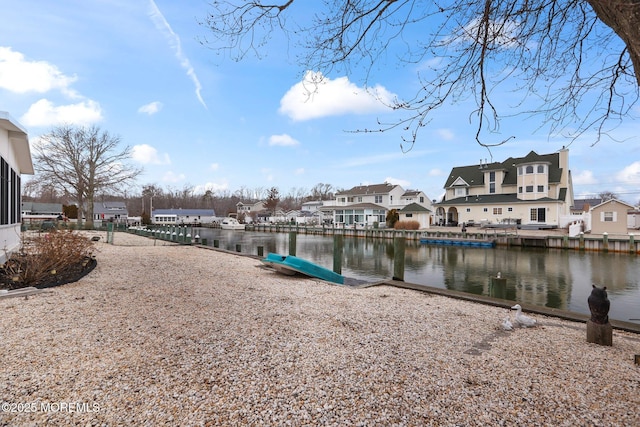 dock area featuring a water view and a residential view