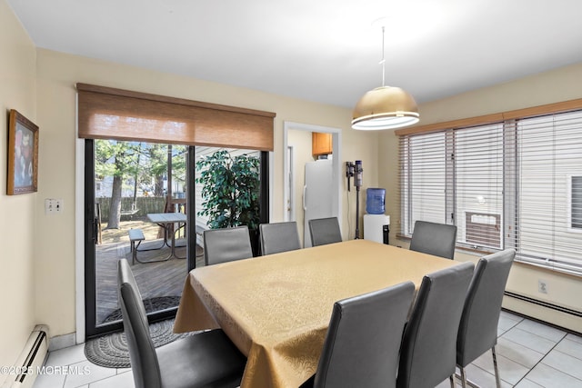 dining space with light tile patterned floors and a baseboard heating unit