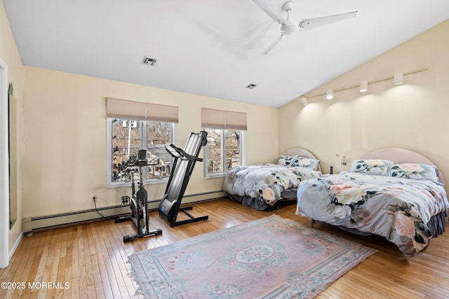 bedroom with visible vents, lofted ceiling, wood-type flooring, and a ceiling fan