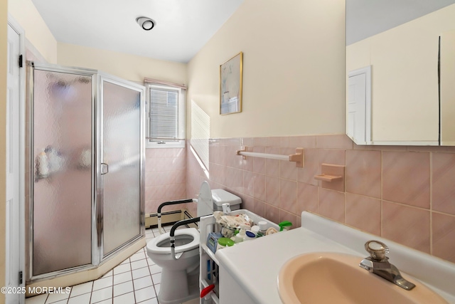 full bath featuring tile patterned flooring, a shower stall, tile walls, toilet, and vanity