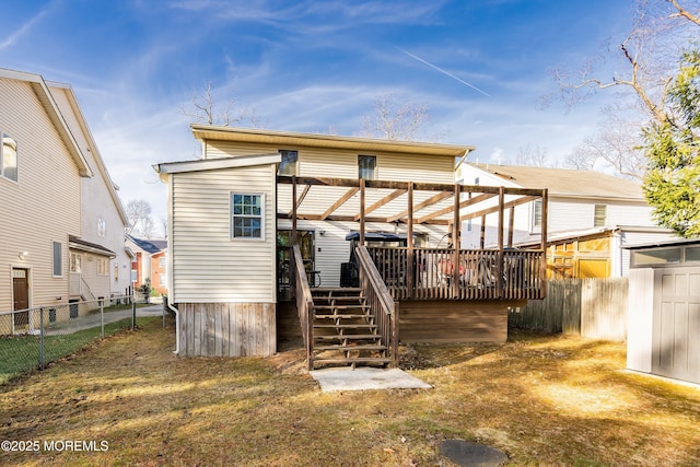 back of property featuring a wooden deck, stairs, and fence