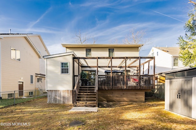 back of house featuring stairs, a deck, and fence