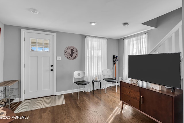 foyer featuring wood finished floors and baseboards