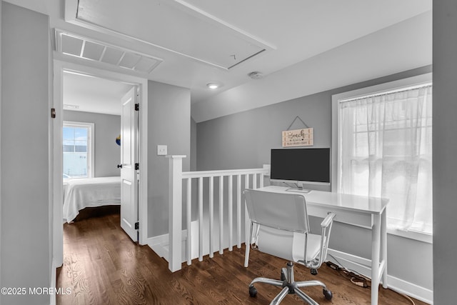 home office with visible vents, attic access, vaulted ceiling, wood finished floors, and baseboards