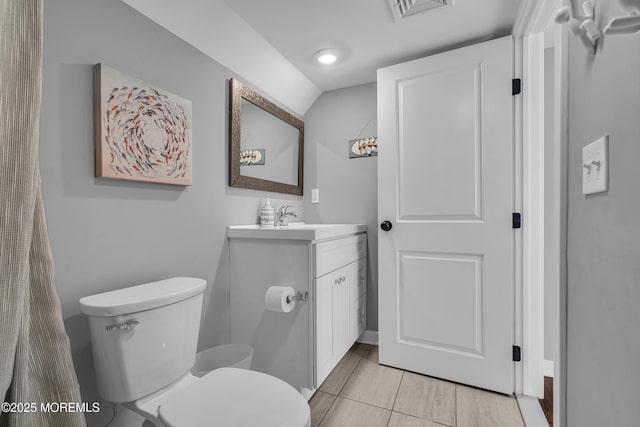 bathroom featuring toilet, visible vents, vaulted ceiling, and vanity