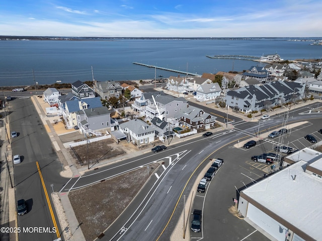 birds eye view of property featuring a water view and a residential view