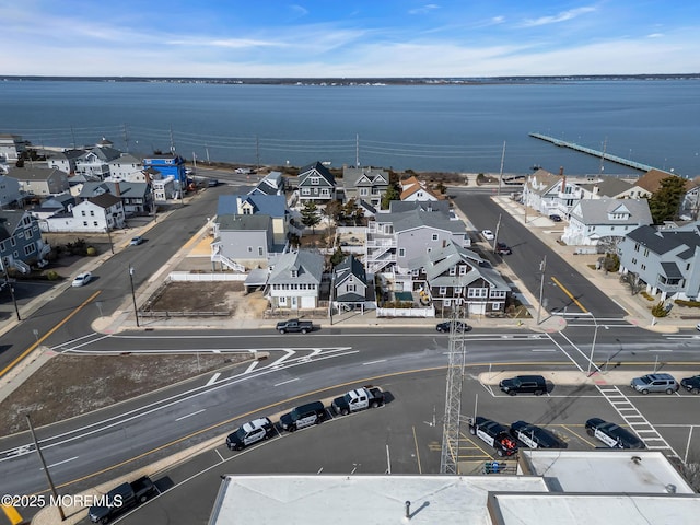 birds eye view of property with a water view and a residential view