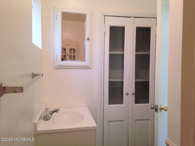 bathroom featuring a closet and vanity