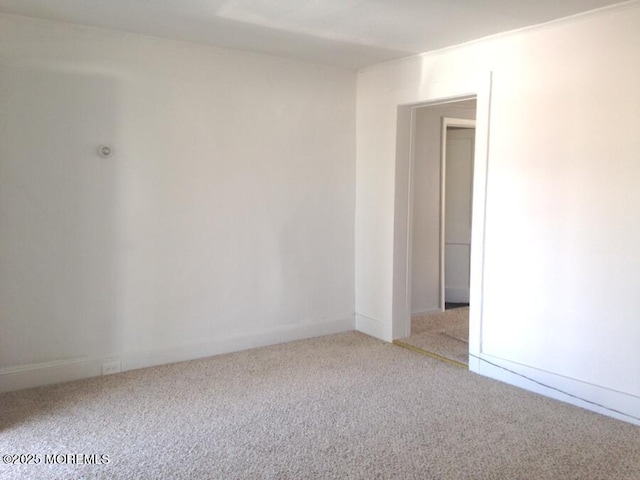 empty room featuring light carpet