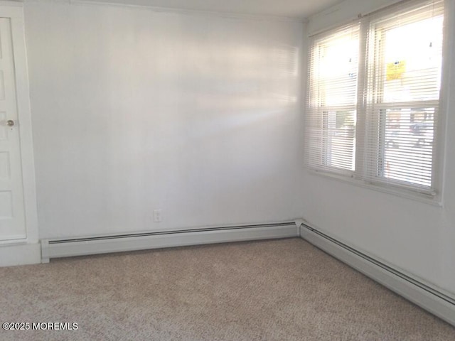 unfurnished room featuring carpet and a baseboard radiator