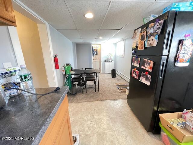 rec room featuring a paneled ceiling, washer / dryer, and light carpet