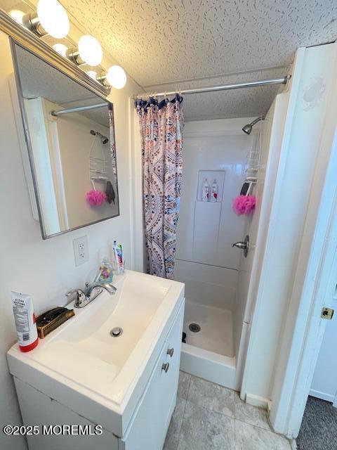 bathroom with a stall shower and vanity