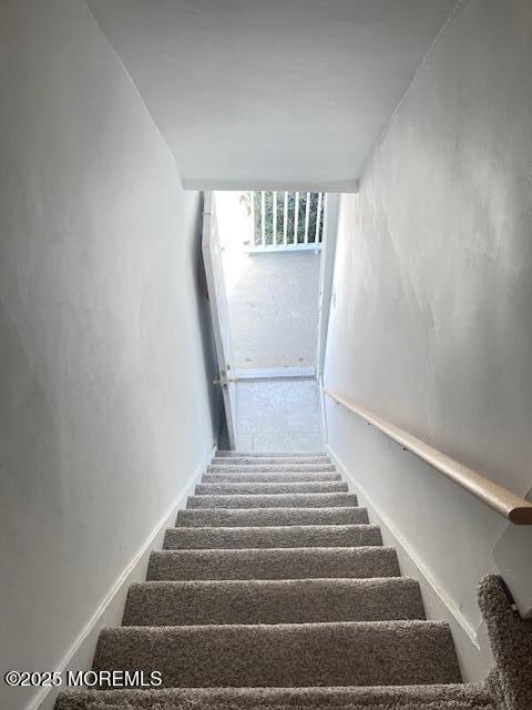 stairway featuring a wall of windows