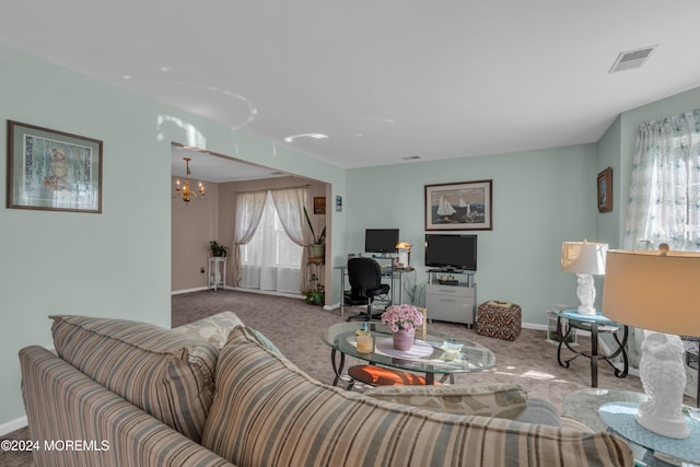 living room with baseboards, visible vents, carpet flooring, and an inviting chandelier