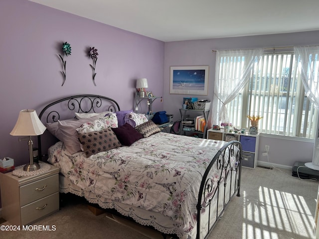 bedroom featuring light carpet, visible vents, and baseboards