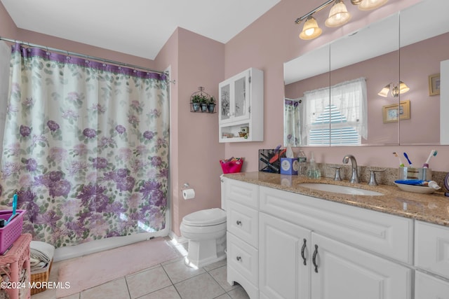 bathroom with vanity, tile patterned flooring, and toilet