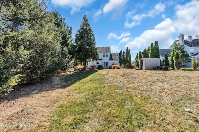 view of yard with an outbuilding and a shed