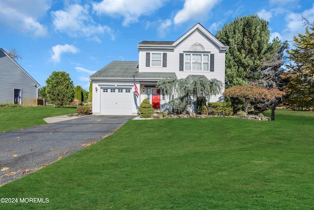 traditional home with a garage, aphalt driveway, and a front yard