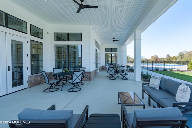 view of patio / terrace with ceiling fan, outdoor dining area, outdoor lounge area, and a swimming pool