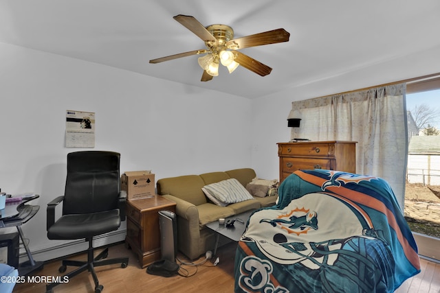 bedroom with a ceiling fan and wood finished floors