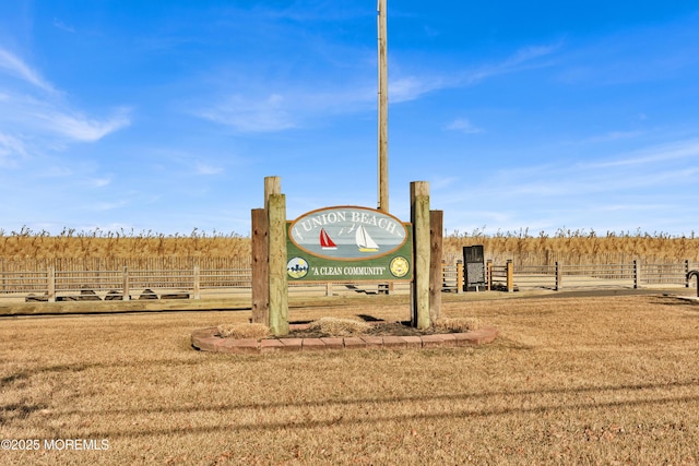 exterior space featuring a yard, a rural view, and fence