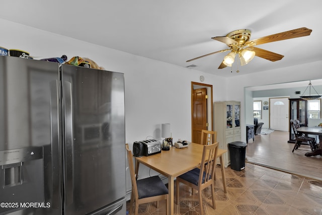 dining area with visible vents and a ceiling fan