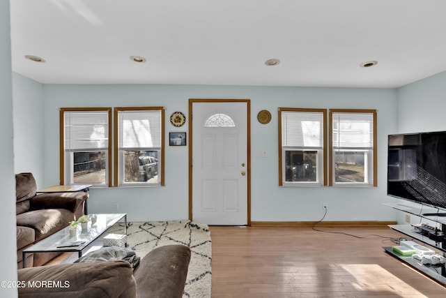 living room featuring recessed lighting, baseboards, and wood finished floors