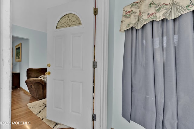 entrance foyer with light wood-style flooring and baseboards