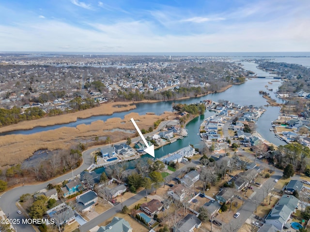 bird's eye view featuring a water view and a residential view