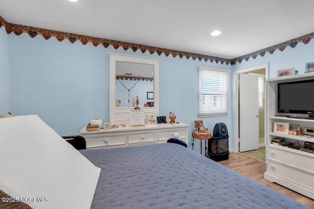 bedroom featuring light wood-style floors and baseboards