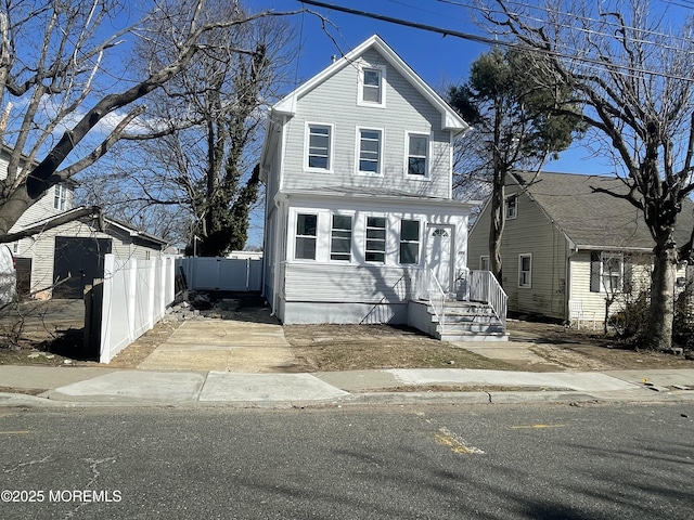 traditional-style home with fence