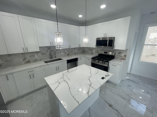 kitchen with marble finish floor, tasteful backsplash, appliances with stainless steel finishes, white cabinets, and a sink