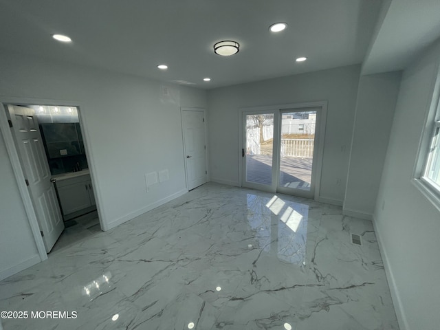 unfurnished room with marble finish floor, recessed lighting, and baseboards