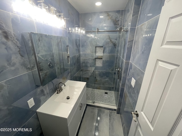 full bath featuring a stall shower and vanity