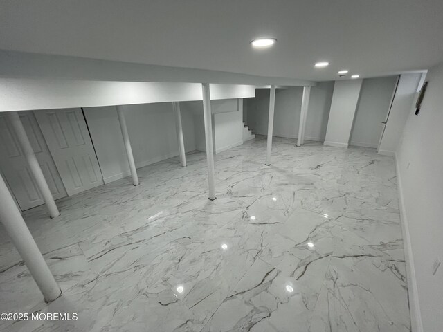 finished basement featuring marble finish floor and recessed lighting