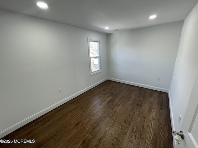 unfurnished room featuring dark wood-style floors, recessed lighting, and baseboards