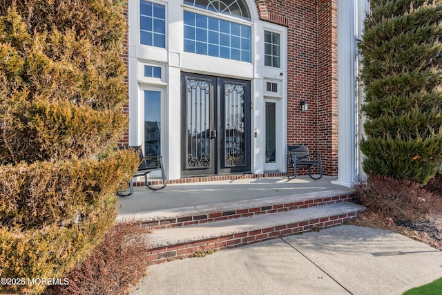 doorway to property with brick siding