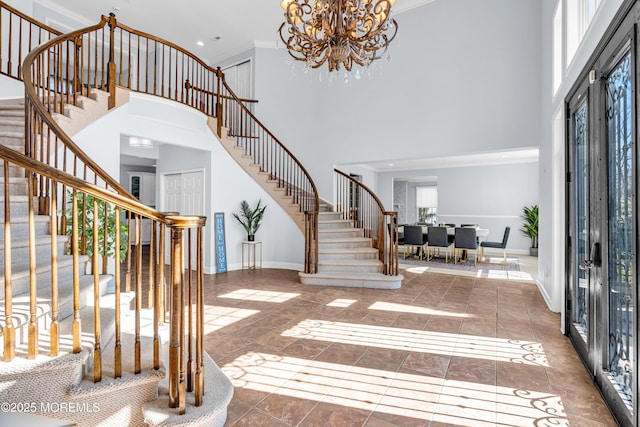 foyer with stairs, baseboards, and crown molding