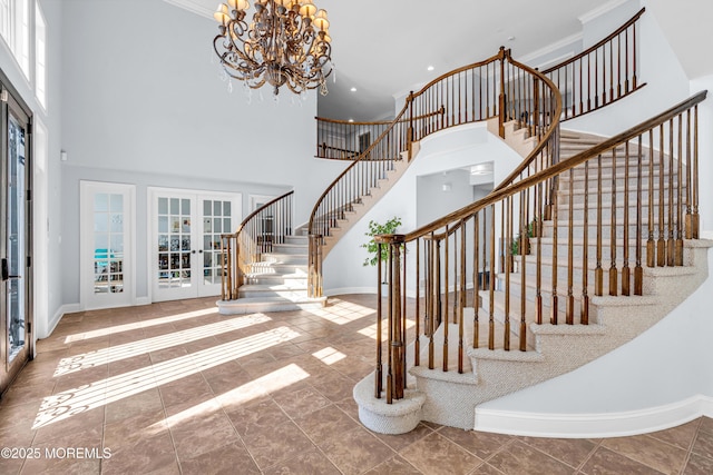 foyer entrance featuring stairs, french doors, ornamental molding, and baseboards