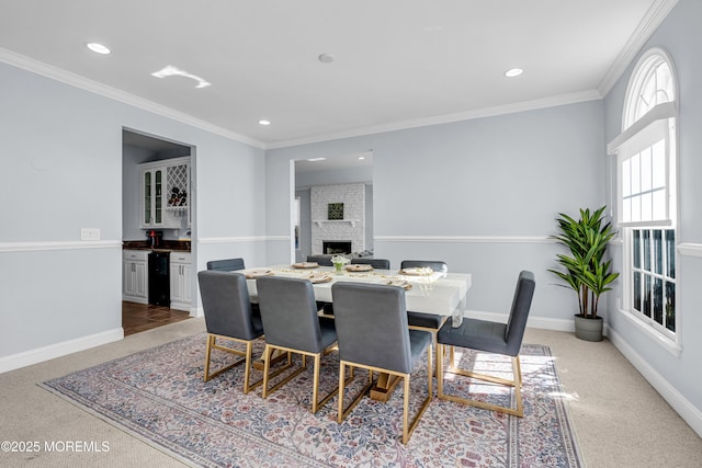 dining area with recessed lighting, a brick fireplace, crown molding, and baseboards