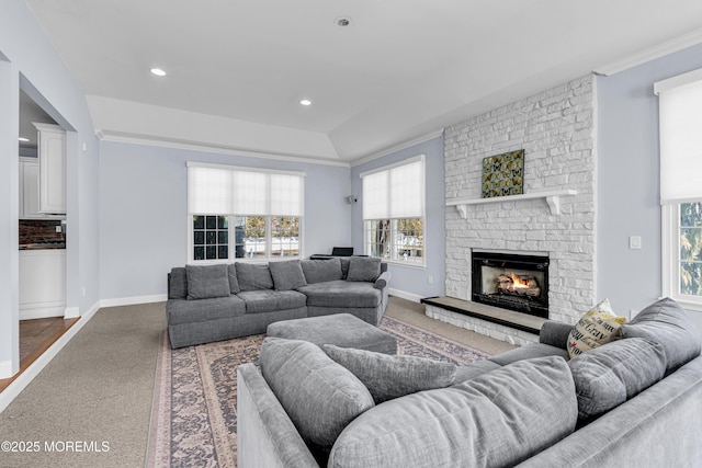 carpeted living room with ornamental molding, recessed lighting, a brick fireplace, and baseboards