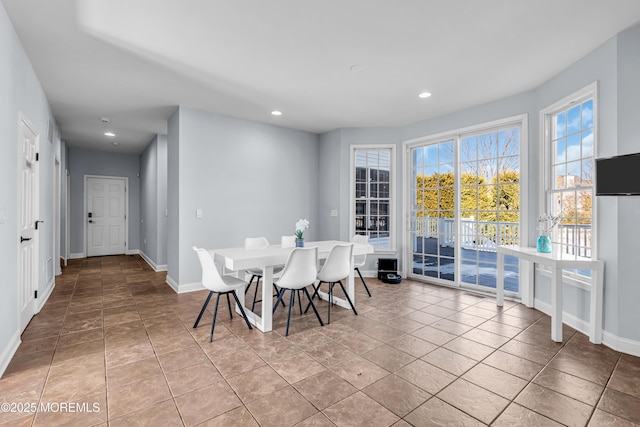 tiled dining area featuring baseboards and recessed lighting