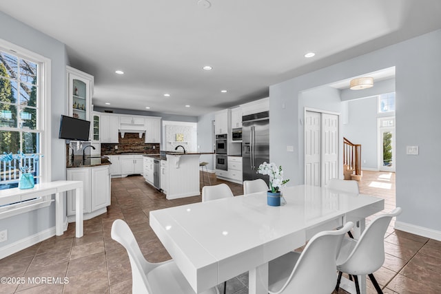 dining room featuring baseboards, dark tile patterned flooring, and recessed lighting