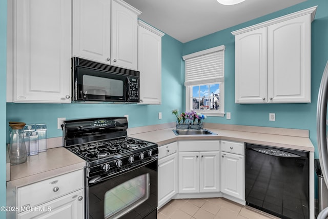 kitchen featuring black appliances, light countertops, and white cabinetry